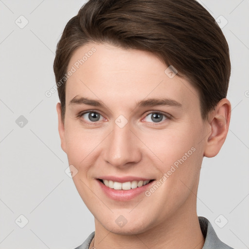 Joyful white young-adult female with short  brown hair and grey eyes