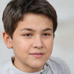 Joyful white child male with short  brown hair and brown eyes