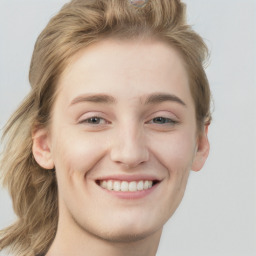 Joyful white young-adult female with long  brown hair and blue eyes