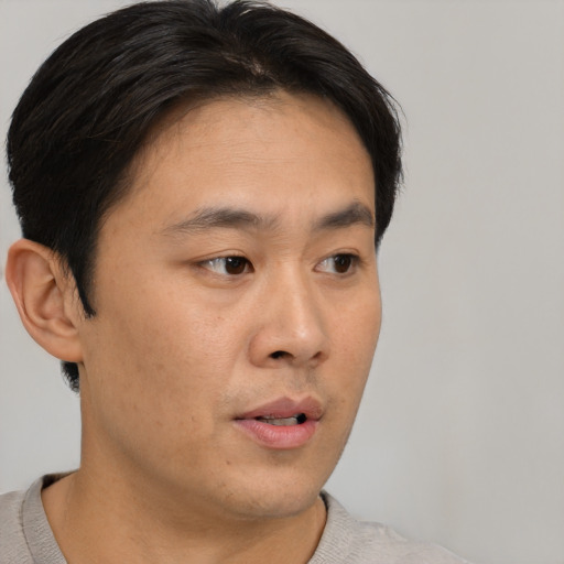 Neutral asian young-adult male with short  brown hair and brown eyes