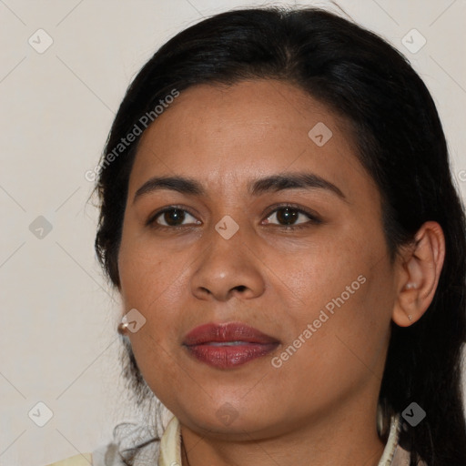 Joyful latino young-adult female with medium  brown hair and brown eyes