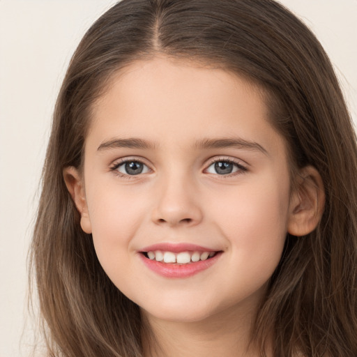 Joyful white child female with long  brown hair and brown eyes