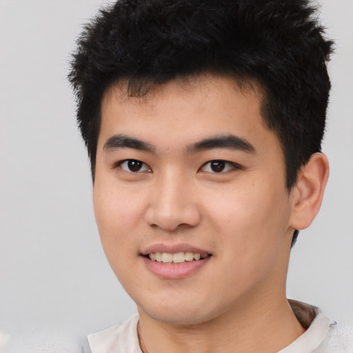 Joyful asian young-adult male with short  black hair and brown eyes