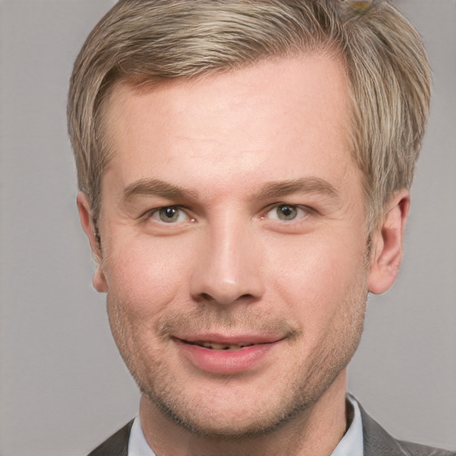 Joyful white adult male with short  brown hair and blue eyes