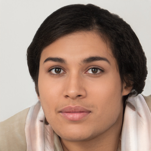 Joyful latino young-adult female with long  brown hair and brown eyes