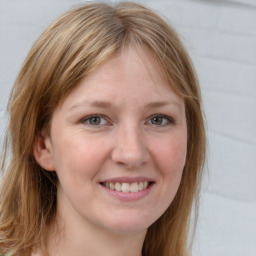 Joyful white young-adult female with long  brown hair and blue eyes