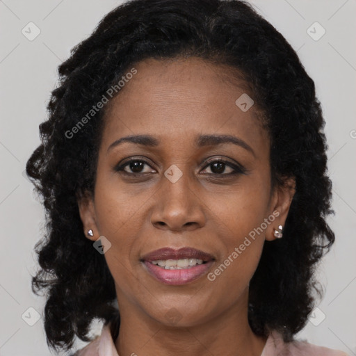 Joyful black adult female with long  black hair and brown eyes