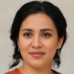 Joyful latino young-adult female with medium  brown hair and brown eyes