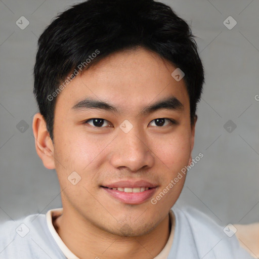 Joyful asian young-adult male with short  brown hair and brown eyes