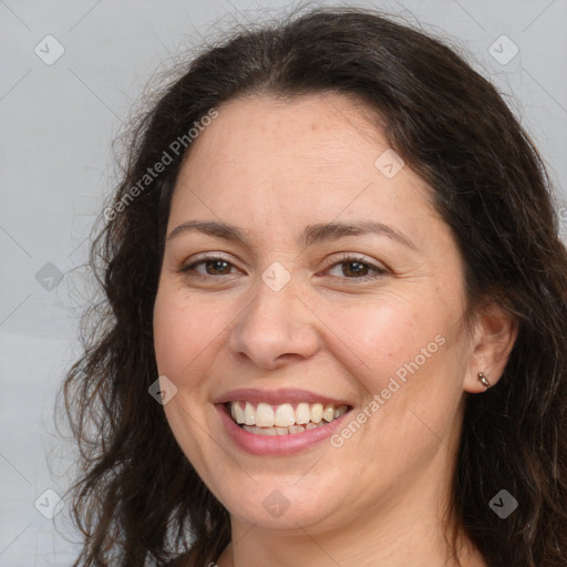 Joyful white adult female with long  brown hair and brown eyes