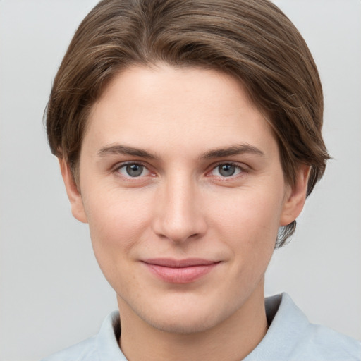 Joyful white young-adult female with short  brown hair and grey eyes