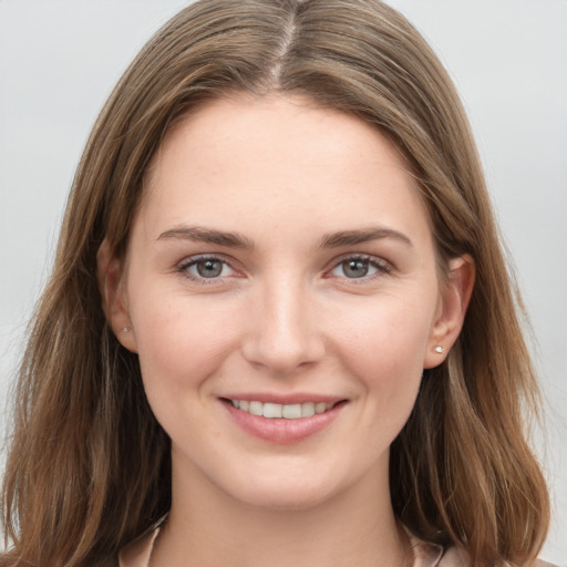 Joyful white young-adult female with medium  brown hair and grey eyes