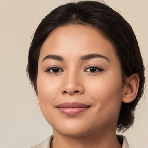 Joyful latino young-adult female with medium  brown hair and brown eyes