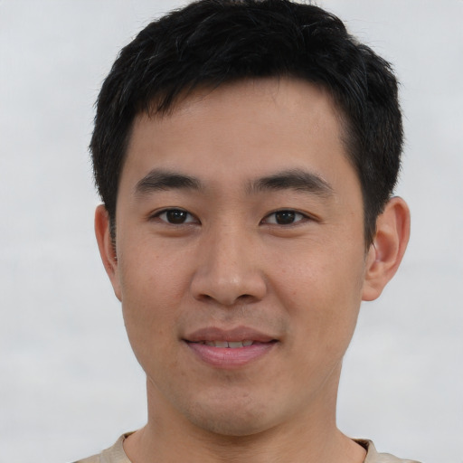 Joyful asian young-adult male with short  brown hair and brown eyes
