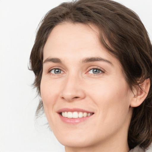 Joyful white young-adult female with medium  brown hair and green eyes