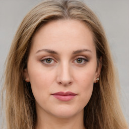 Joyful white young-adult female with long  brown hair and green eyes