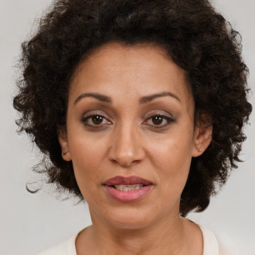Joyful white adult female with medium  brown hair and brown eyes
