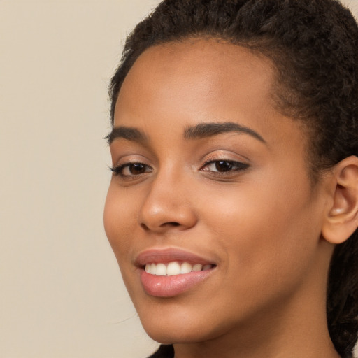 Joyful latino young-adult female with long  brown hair and brown eyes