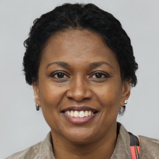 Joyful latino adult female with short  brown hair and brown eyes