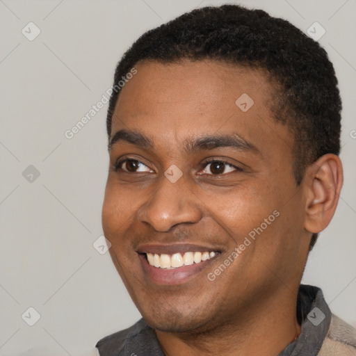 Joyful black young-adult male with short  brown hair and brown eyes