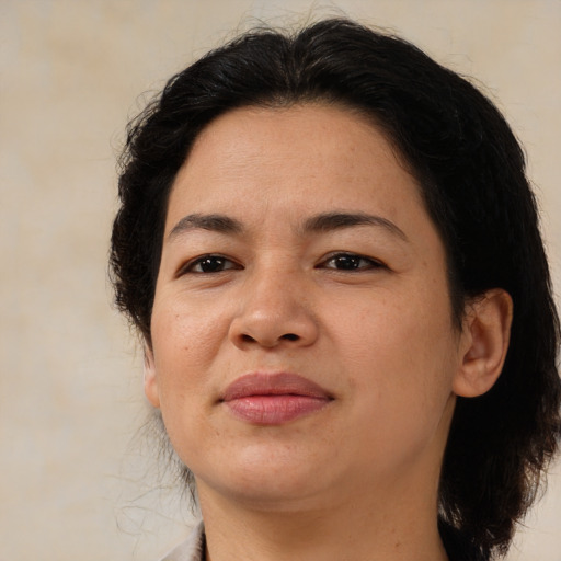 Joyful latino adult female with medium  brown hair and brown eyes