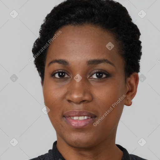 Joyful black young-adult female with short  black hair and brown eyes