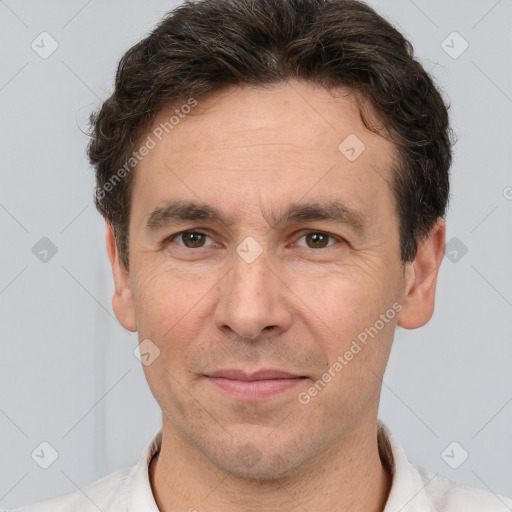 Joyful white adult male with short  brown hair and brown eyes