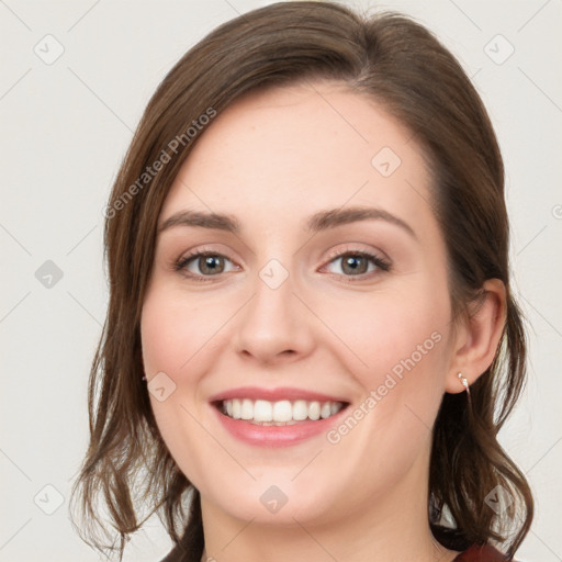 Joyful white young-adult female with medium  brown hair and blue eyes