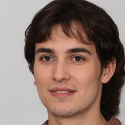 Joyful white young-adult male with medium  brown hair and brown eyes