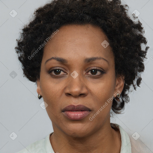 Joyful black adult female with short  black hair and brown eyes