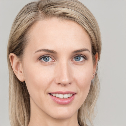 Joyful white young-adult female with medium  brown hair and blue eyes