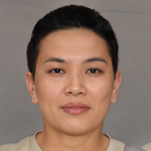 Joyful asian young-adult female with short  black hair and brown eyes