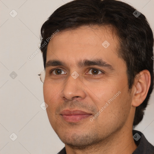 Joyful white young-adult male with short  black hair and brown eyes