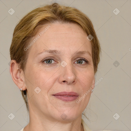 Joyful white adult female with short  brown hair and blue eyes