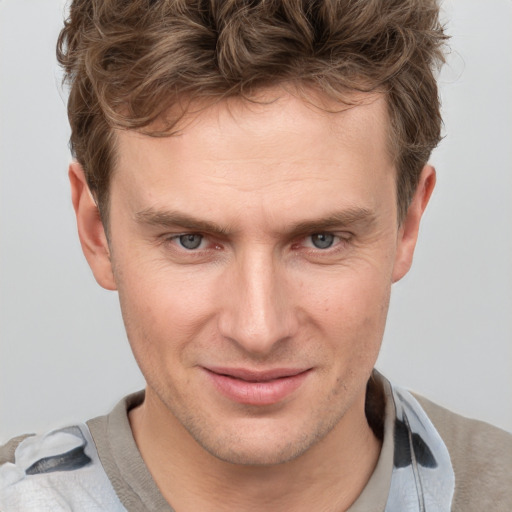 Joyful white adult male with short  brown hair and grey eyes