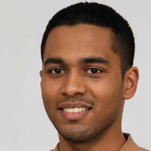 Joyful black young-adult male with short  black hair and brown eyes