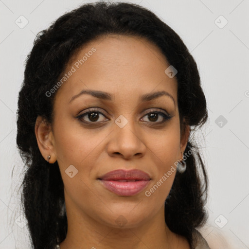 Joyful black young-adult female with long  brown hair and brown eyes