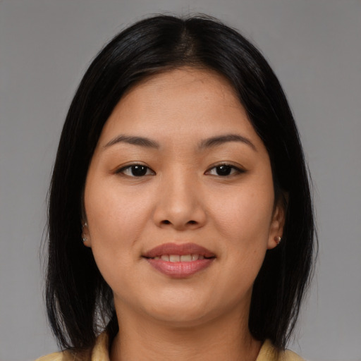 Joyful asian young-adult female with medium  brown hair and brown eyes