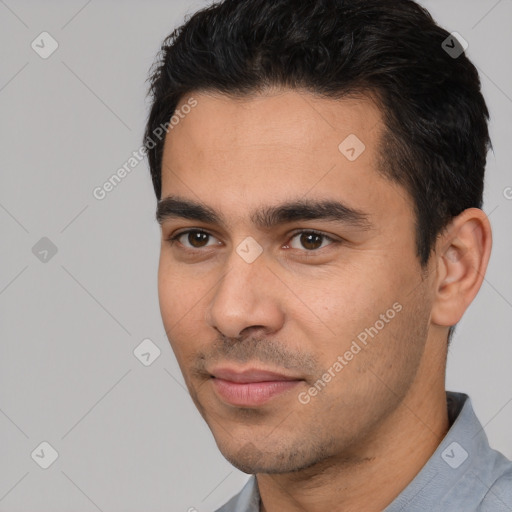 Joyful white young-adult male with short  black hair and brown eyes