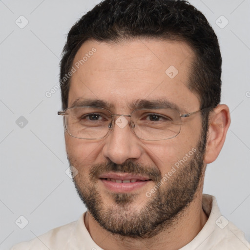 Joyful white adult male with short  brown hair and brown eyes