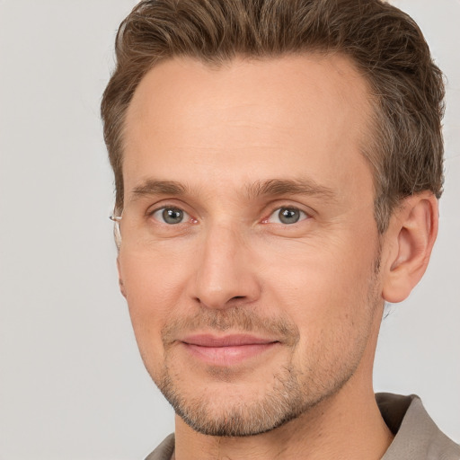 Joyful white adult male with short  brown hair and brown eyes