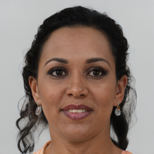Joyful black adult female with medium  brown hair and brown eyes