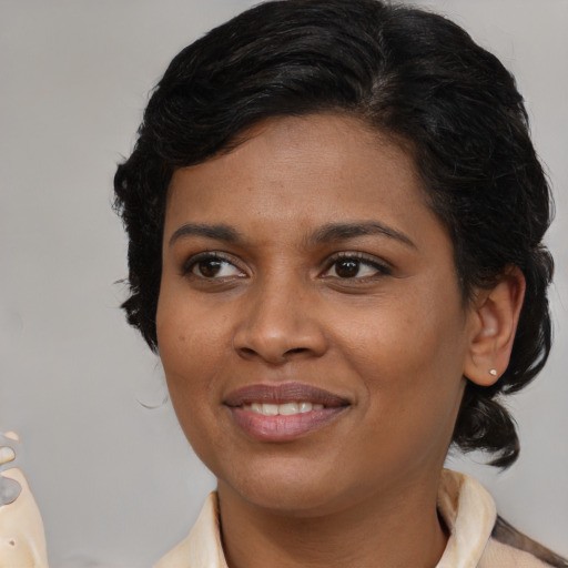 Joyful black young-adult female with medium  brown hair and brown eyes