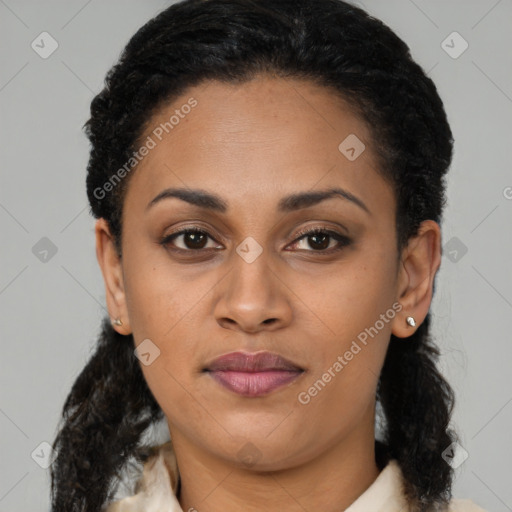 Joyful black young-adult female with long  brown hair and brown eyes