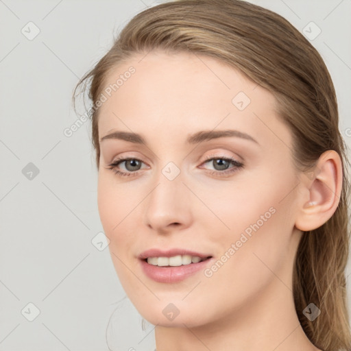 Joyful white young-adult female with long  brown hair and blue eyes