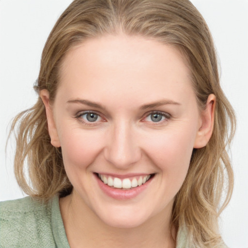 Joyful white young-adult female with medium  brown hair and blue eyes