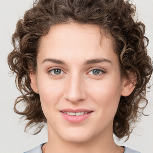 Joyful white young-adult female with medium  brown hair and green eyes