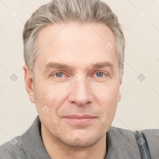 Joyful white adult male with short  brown hair and grey eyes