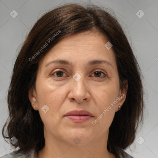 Joyful white adult female with medium  brown hair and brown eyes