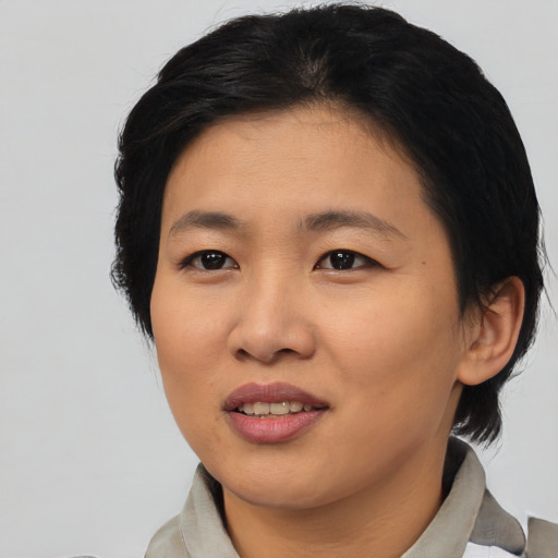 Joyful asian young-adult female with medium  black hair and brown eyes